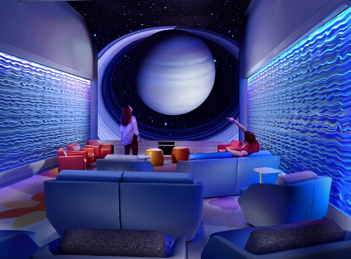 Cinema looking space called the Imagine Room with photo of Saturn in background